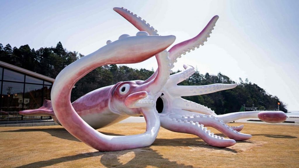 A giant squid statue is erected with the COVID Scholarship