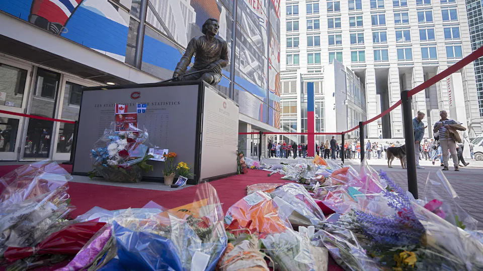 Hundreds of flower bouquets were placed at the foot of the Guy Lafleur Monument, outside the Bell Center.