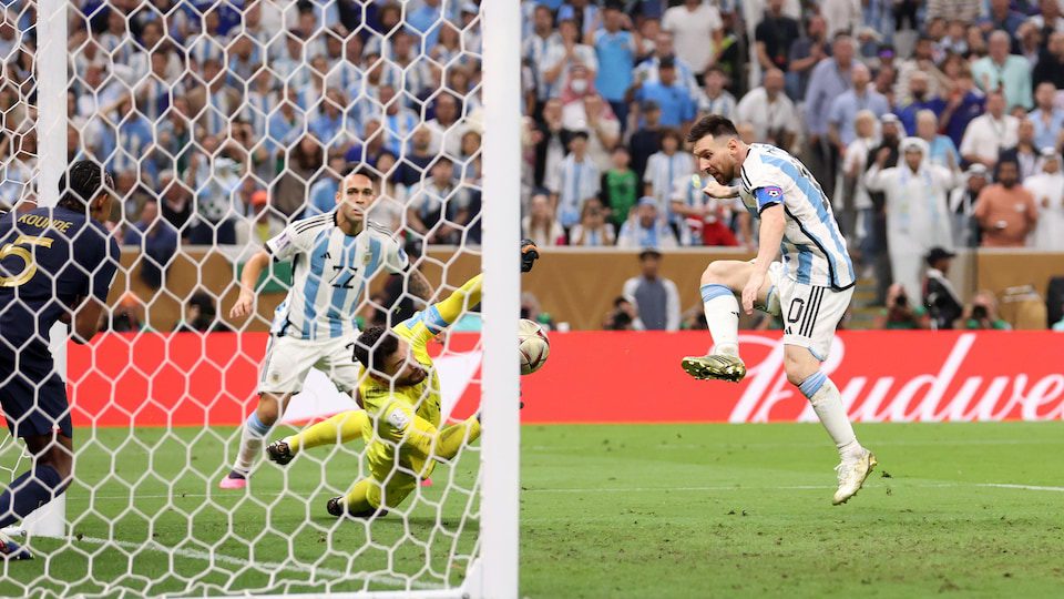 At the entrance to the French goal, Lionel Messi looks at the ball he just kicked with his right foot as goalkeeper Hugo Lloris dives in, unable to make a second save.